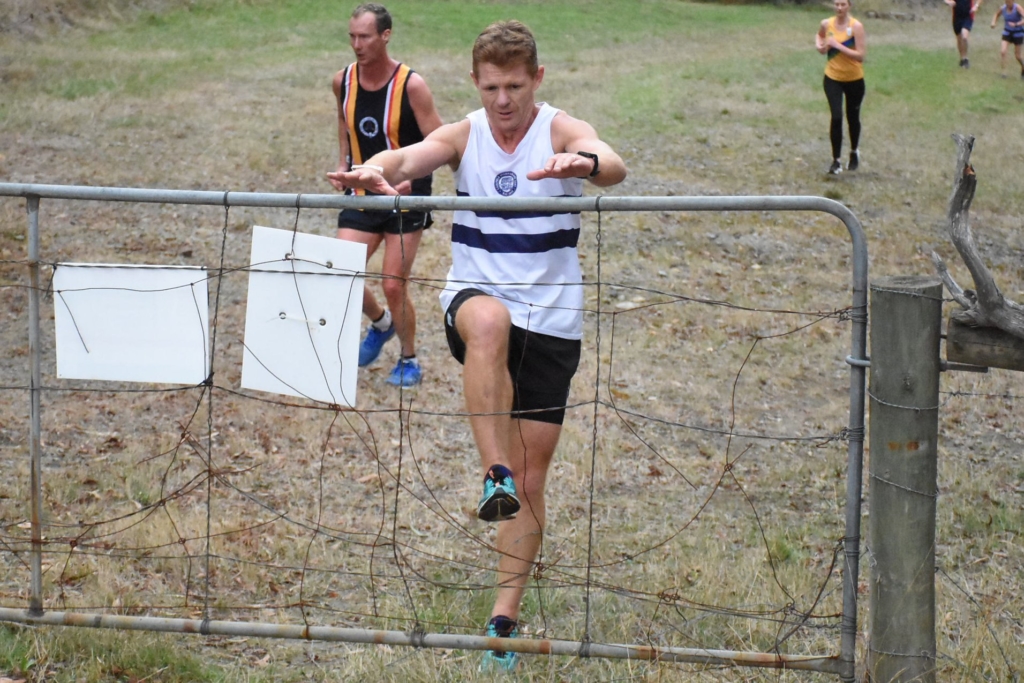 Mark Frater jumping over a fence during an APSOC cross country race