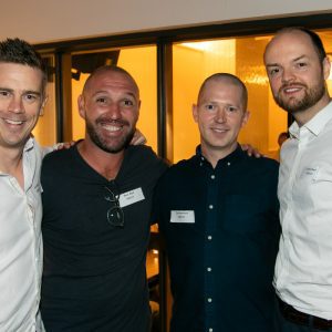 four men posing for the camera