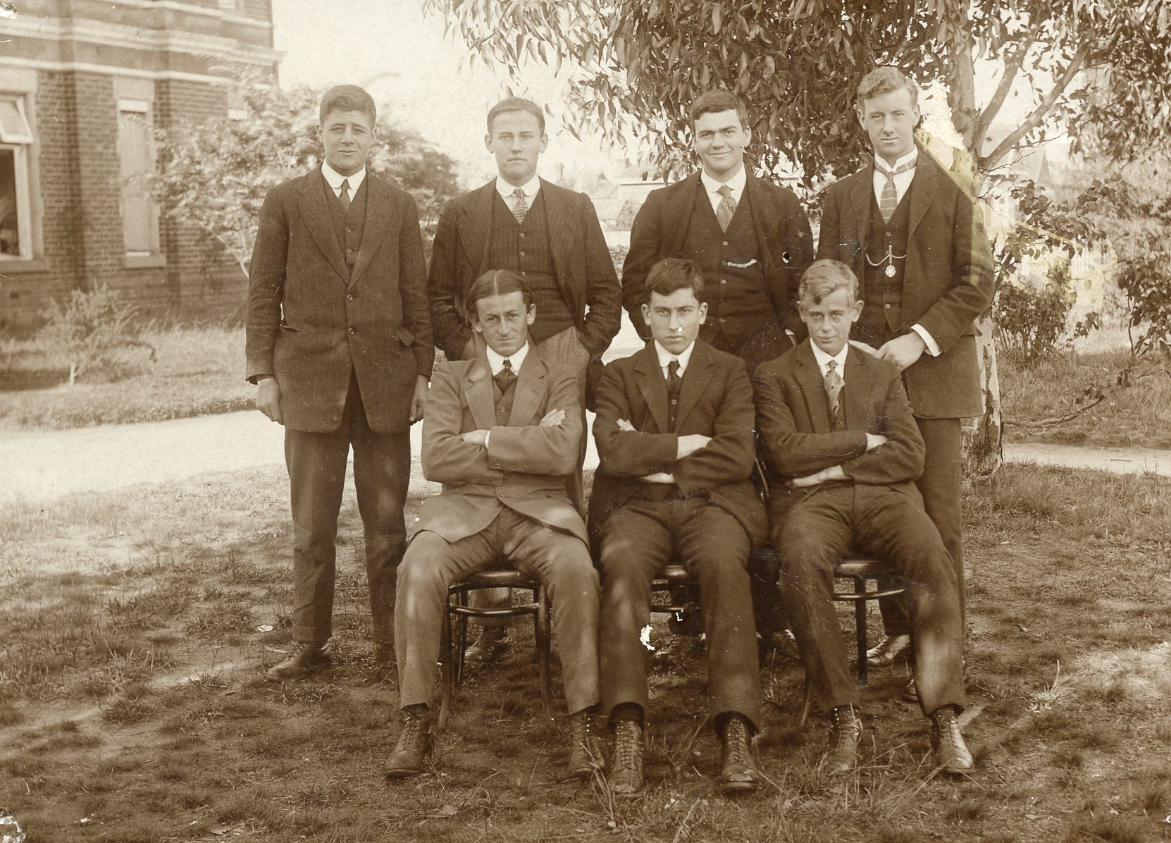 a group of men in suits and ties posing for a picture