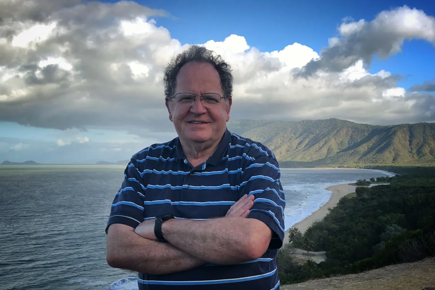 Vale Andrew Herington standing on top of a hill next to the ocean