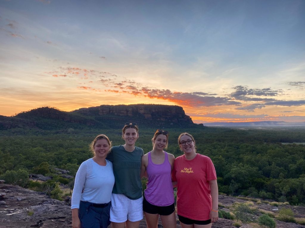 a group of people standing on top of a mountain