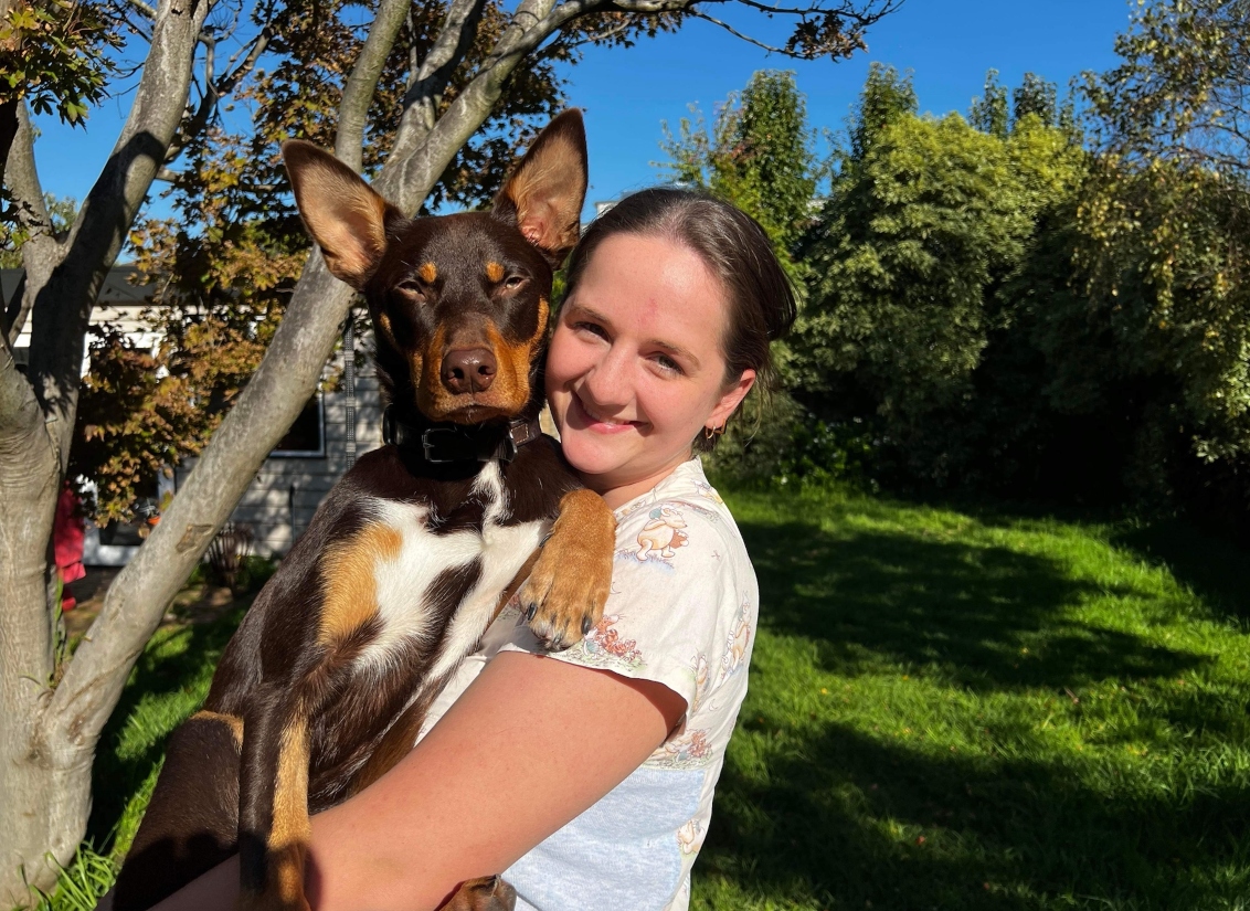 a woman is holding a dog in her arms