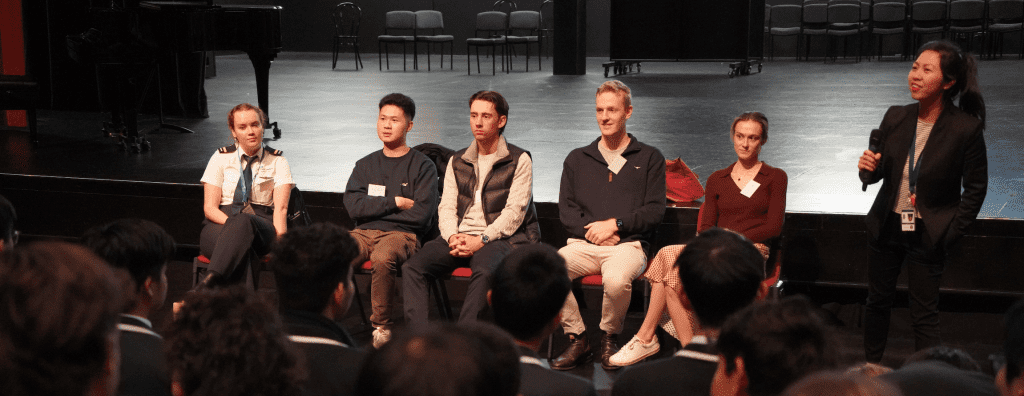 a group of people sitting next to each other on a stage at Student Futures Immersion Day