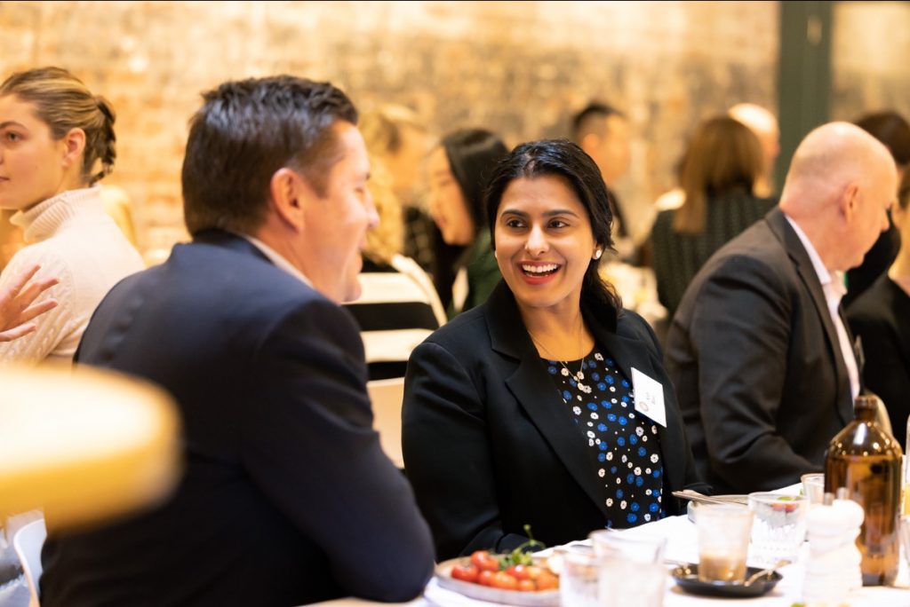 a couple of people sitting at a table at Reverse Mentoring Drinks & Canapés